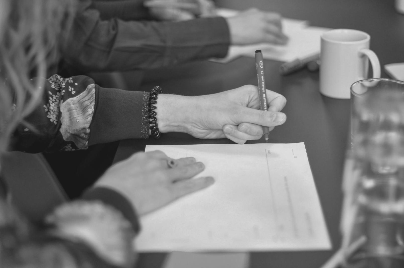 International students participating in a language support session, practicing financial terminology in small groups